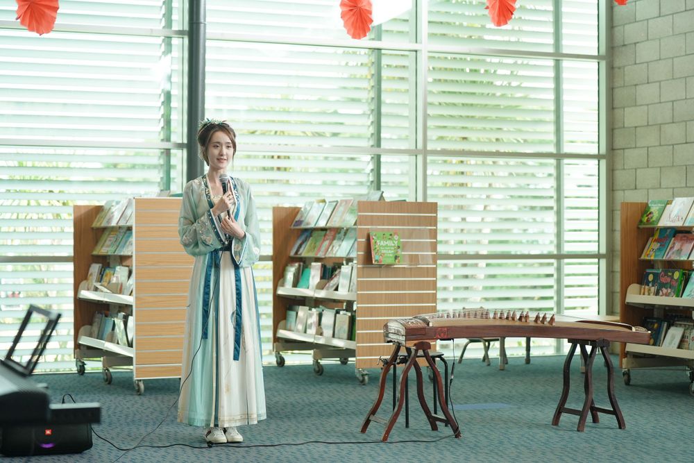 Library New Year event photography featuring a beautiful traditional Hanfu Guzheng performance, by an Auckland photographer.