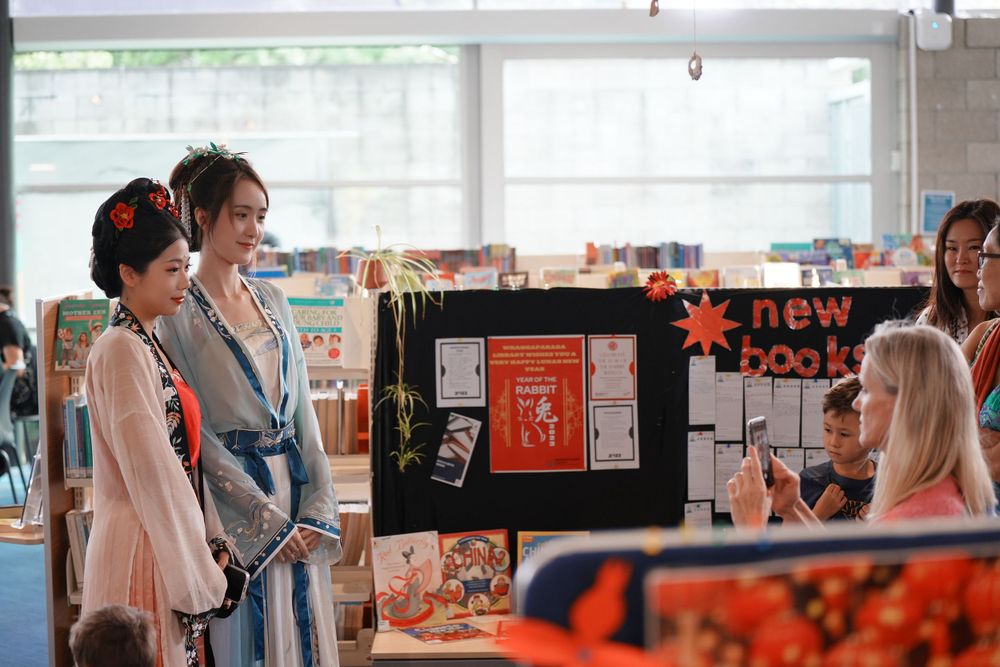 Library New Year event photography featuring a beautiful traditional Hanfu Guzheng performance, by an Auckland photographer.