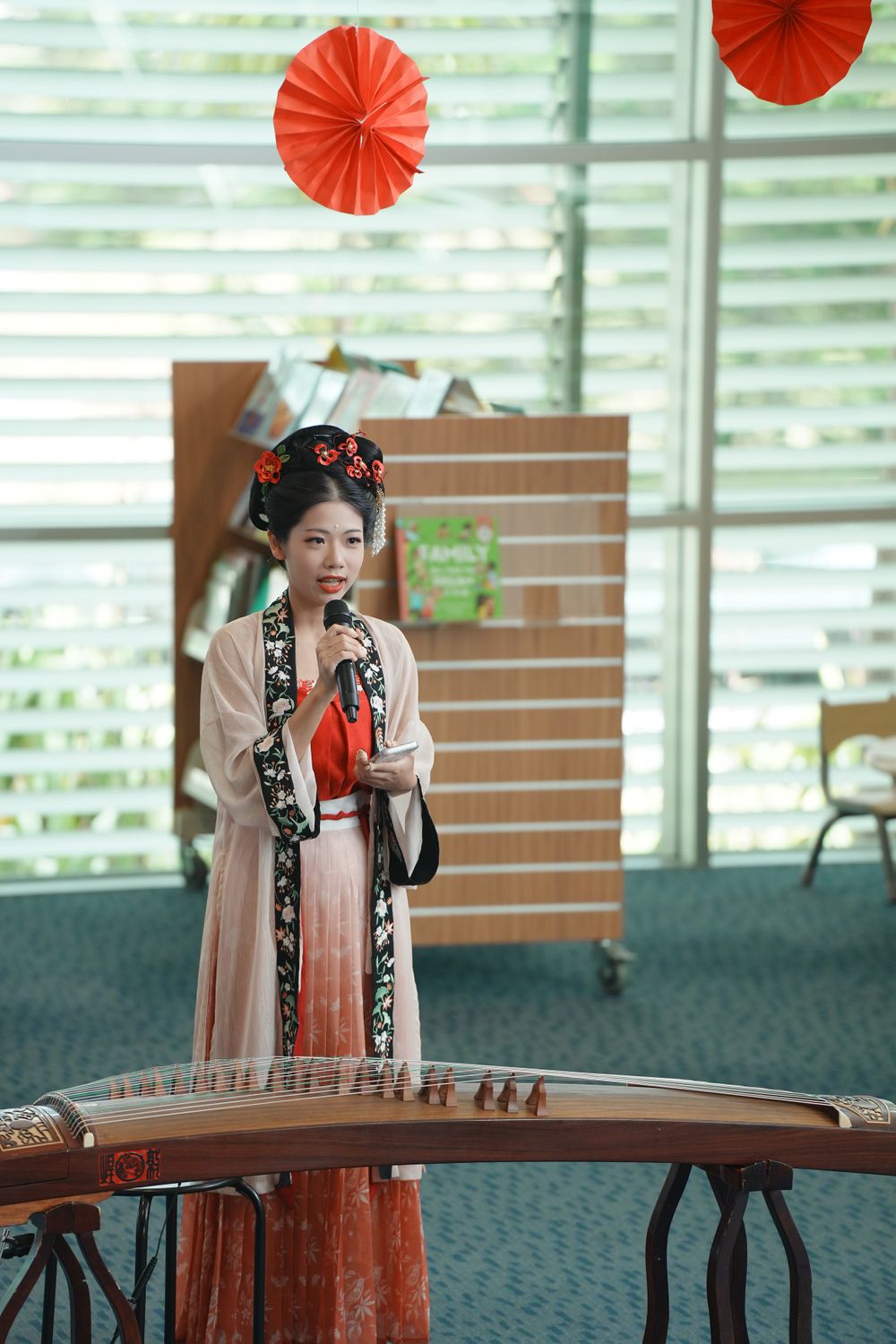 Library New Year event photography featuring a beautiful traditional Hanfu Guzheng performance, by an Auckland photographer.