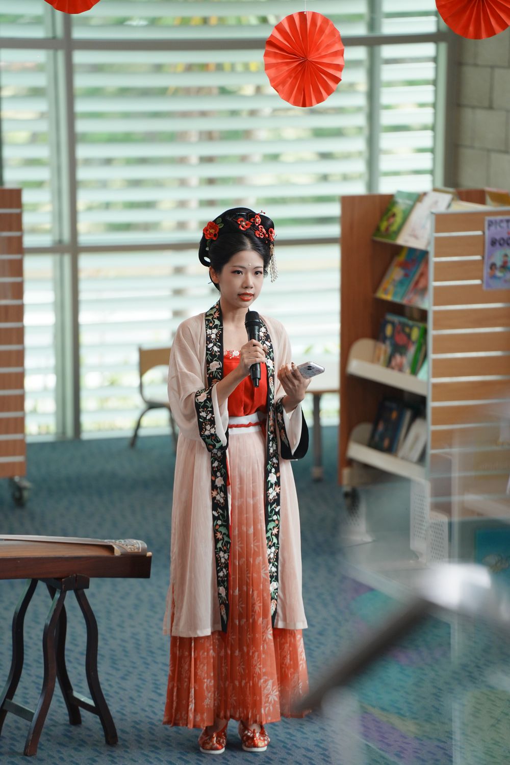 Library New Year event photography featuring a beautiful traditional Hanfu Guzheng performance, by an Auckland photographer.
