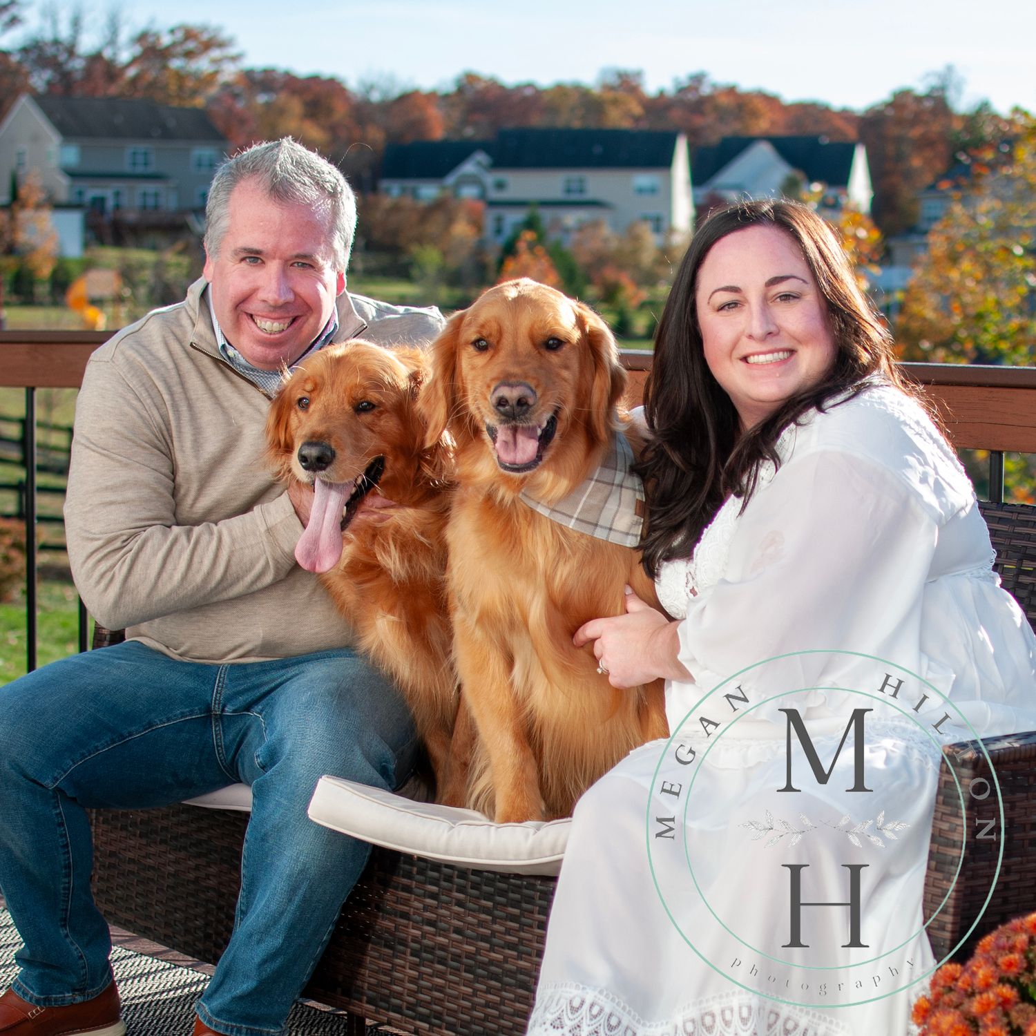 two adults with two dogs image
