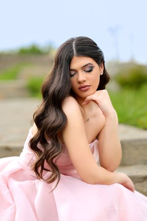 Soft pink fabric drapes elegantly in an outdoor portrait series.