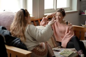 Two friends sharing a relaxed moment while studying together in a casual setting.