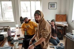 Students working together in a cozy study room with natural light streaming through windows.
