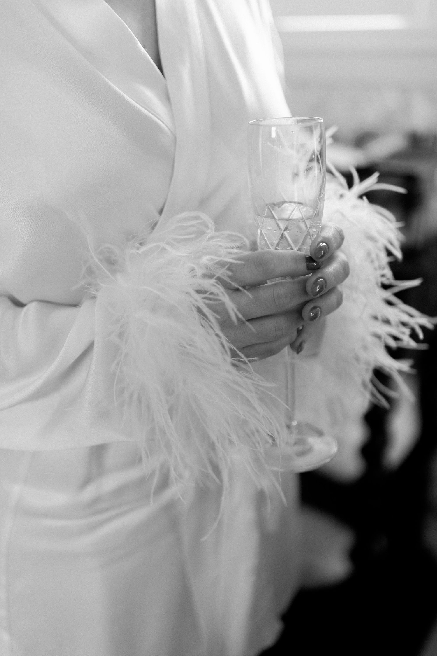 A series of soft, ethereal black and white close-up photos showing delicate white feathers against dark background.