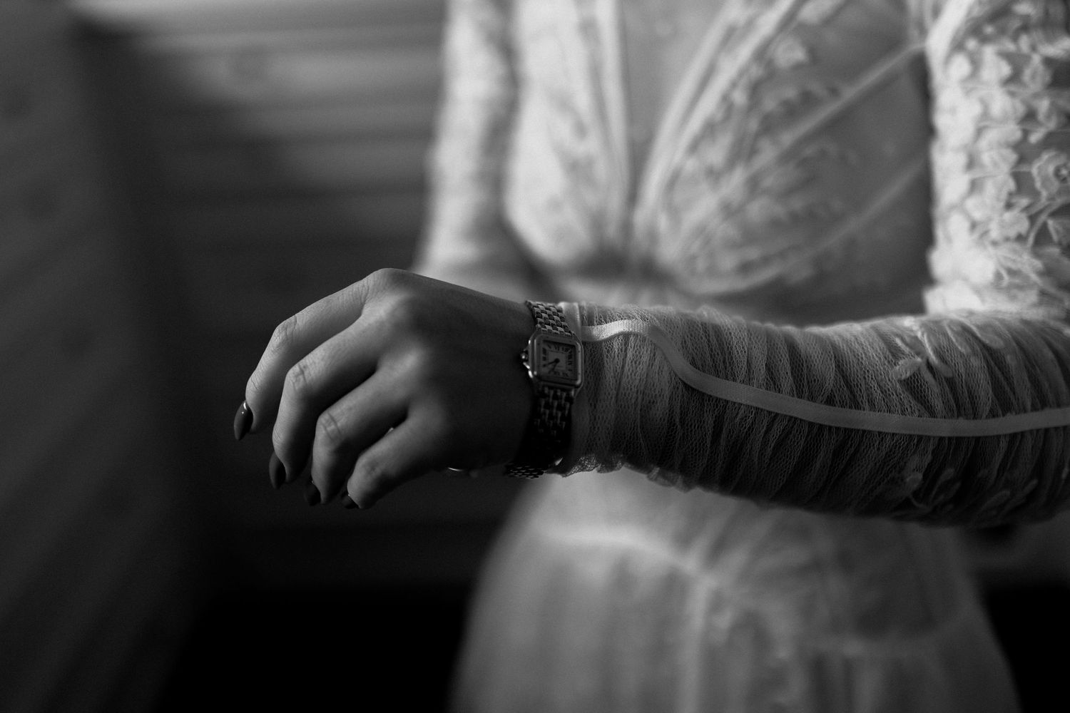 Black and white artistic photos showing details of someone wearing an ornate lace dress with long sleeves.