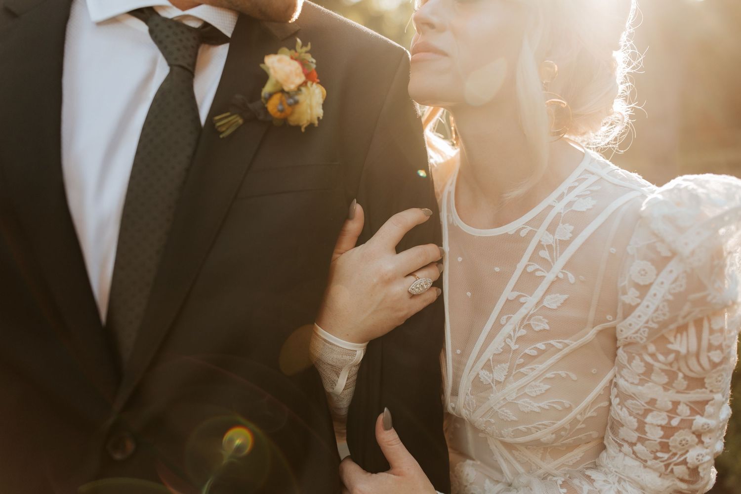 The couple shares a beautiful dance moment together at their wedding reception in warm lighting.