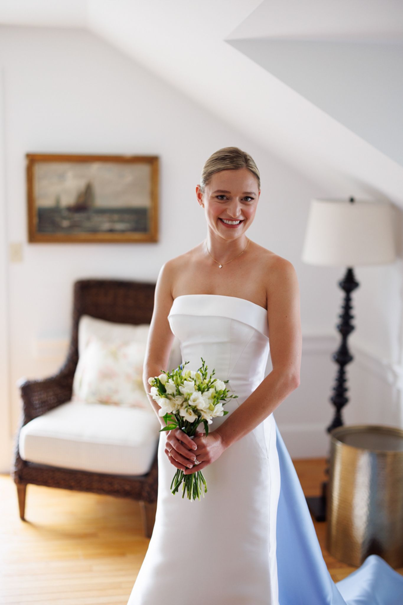 Elegant bridal portrait in a classic white wedding gown with bouquet.