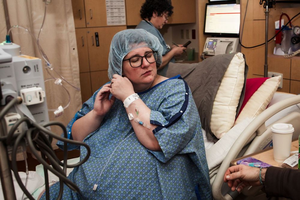 Patient resting in hospital bed while receiving medical care.