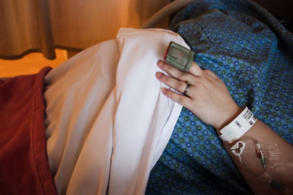 Close-up of medical equipment and blue hospital gown fabric.