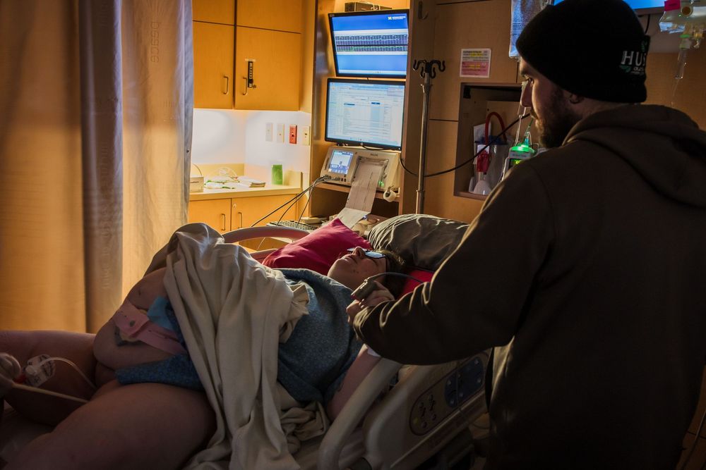 Hospital room interior with warm lighting and medical equipment visible.