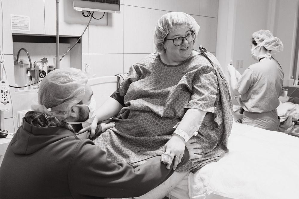 Medical team working together in a hospital delivery room.