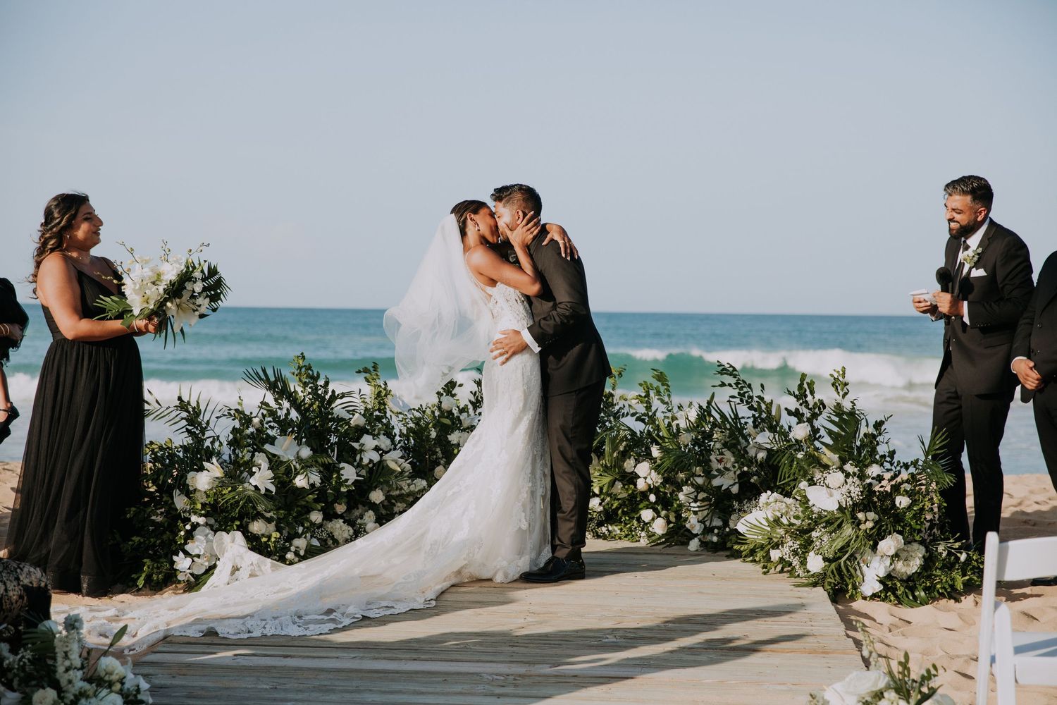 Romantic beach wedding ceremony with ocean backdrop and tropical decor.