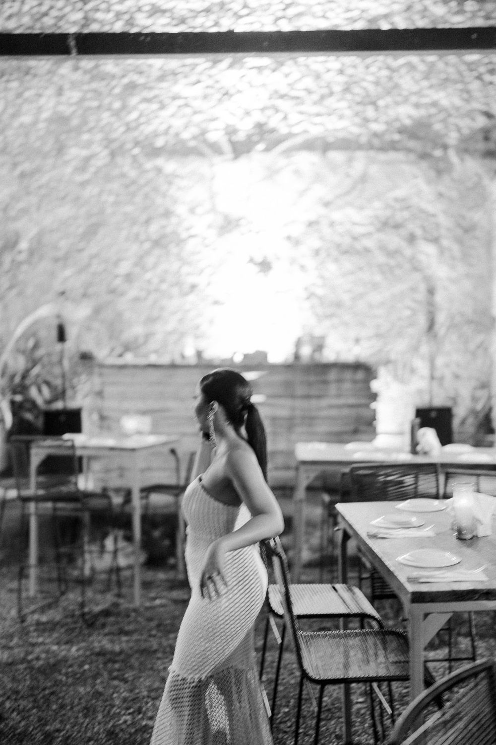 Artistic black and white panoramic series showing silhouette in polka dot dress against blurred background.