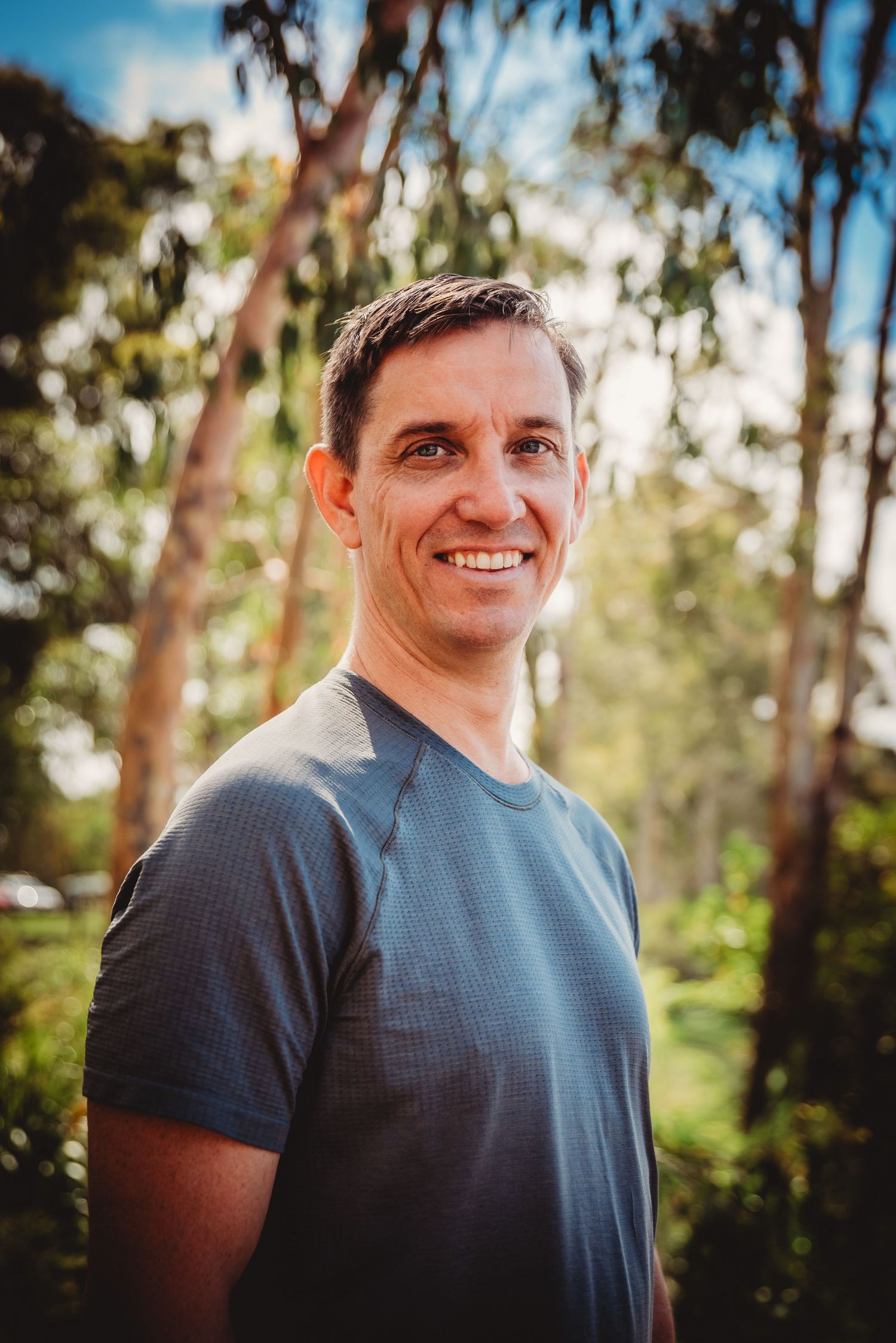 A sequence of outdoor portrait photos showing someone in a blue shirt against a natural forest background in warm lighting.
