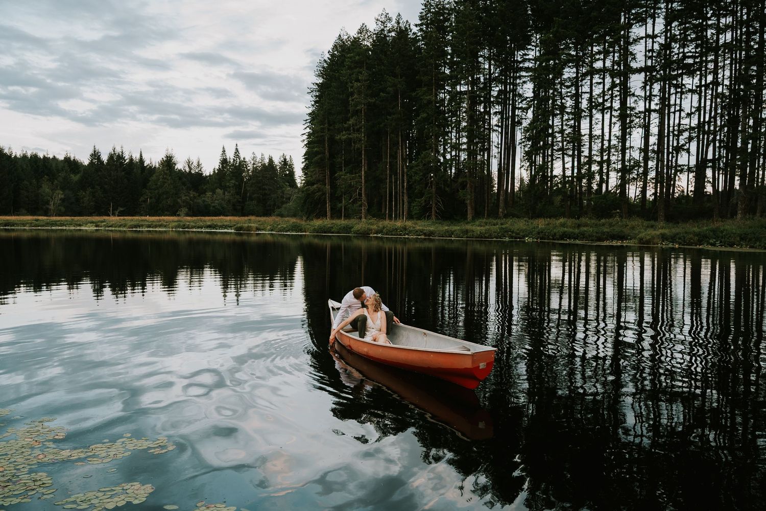 Photography of couple getting into canoe on their wedding day at Smith Lake Farm wedding venue Comox Valley Vancouver Island Photographer