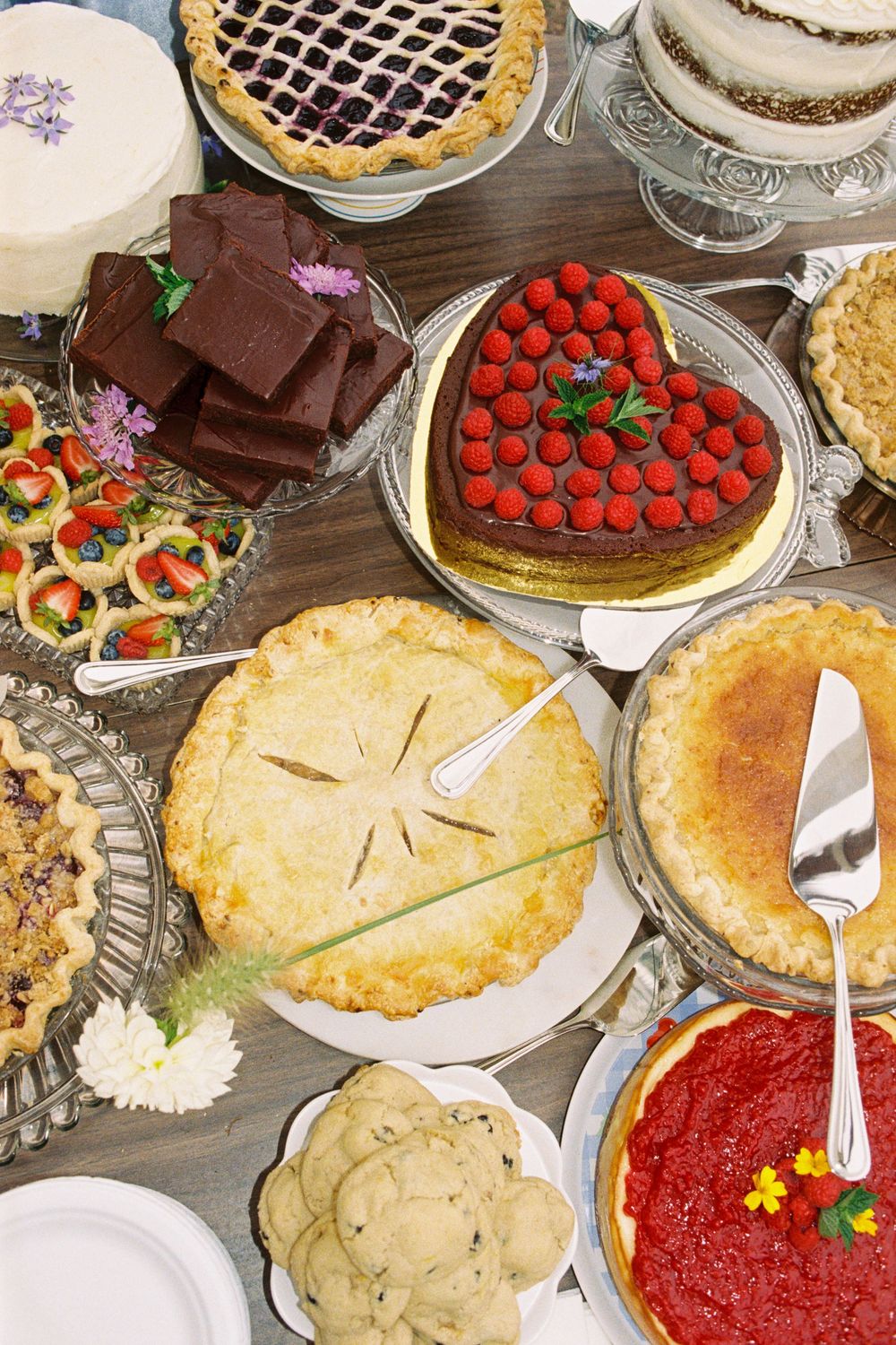 Tablescape of wedding desserts brought by all the guests for this coastal summer wedding in downeast Brooklyn, Maine.