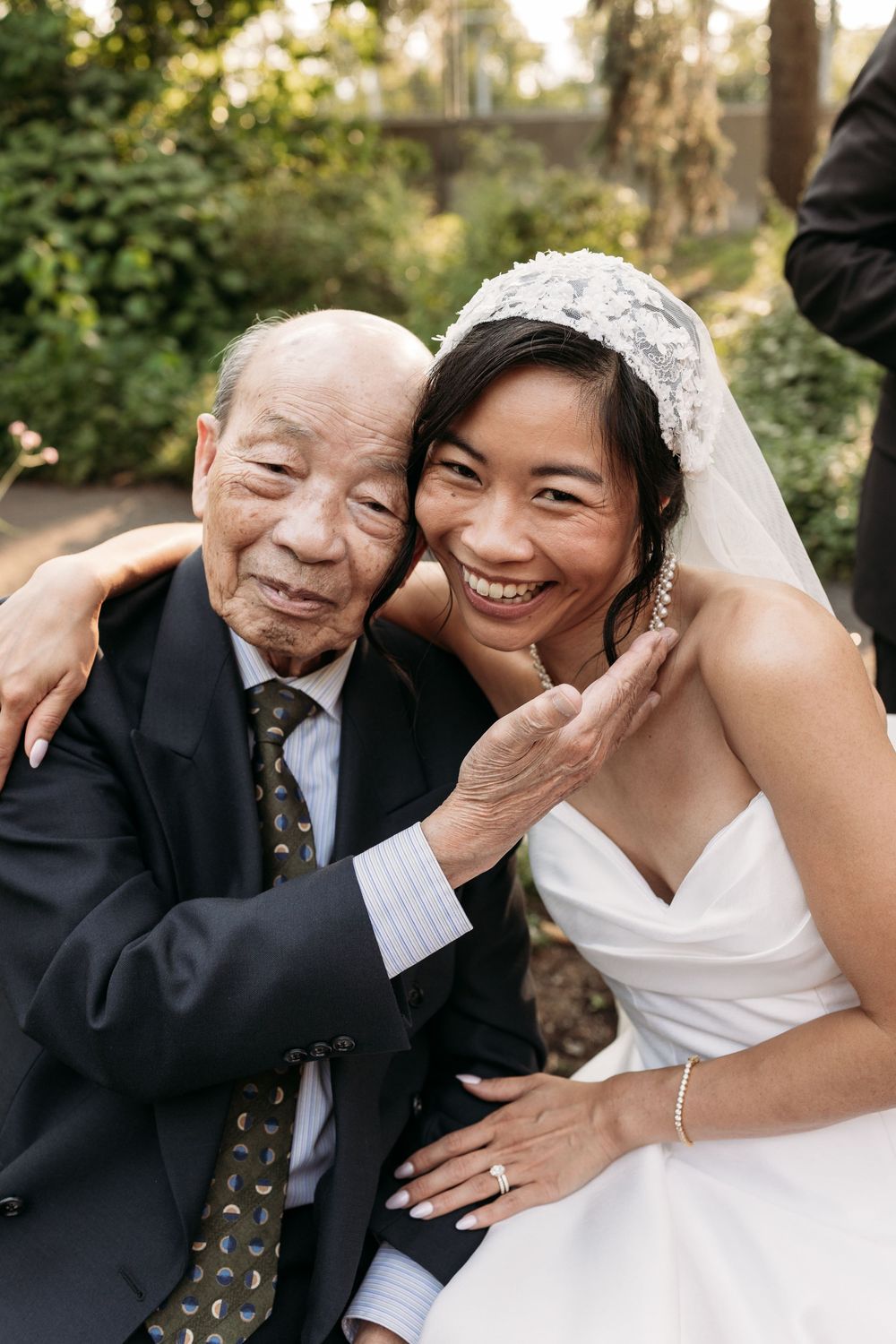 A touching series of joyful wedding photos showing sweet candid interactions between the bride and a guest at an outdoor venue.
