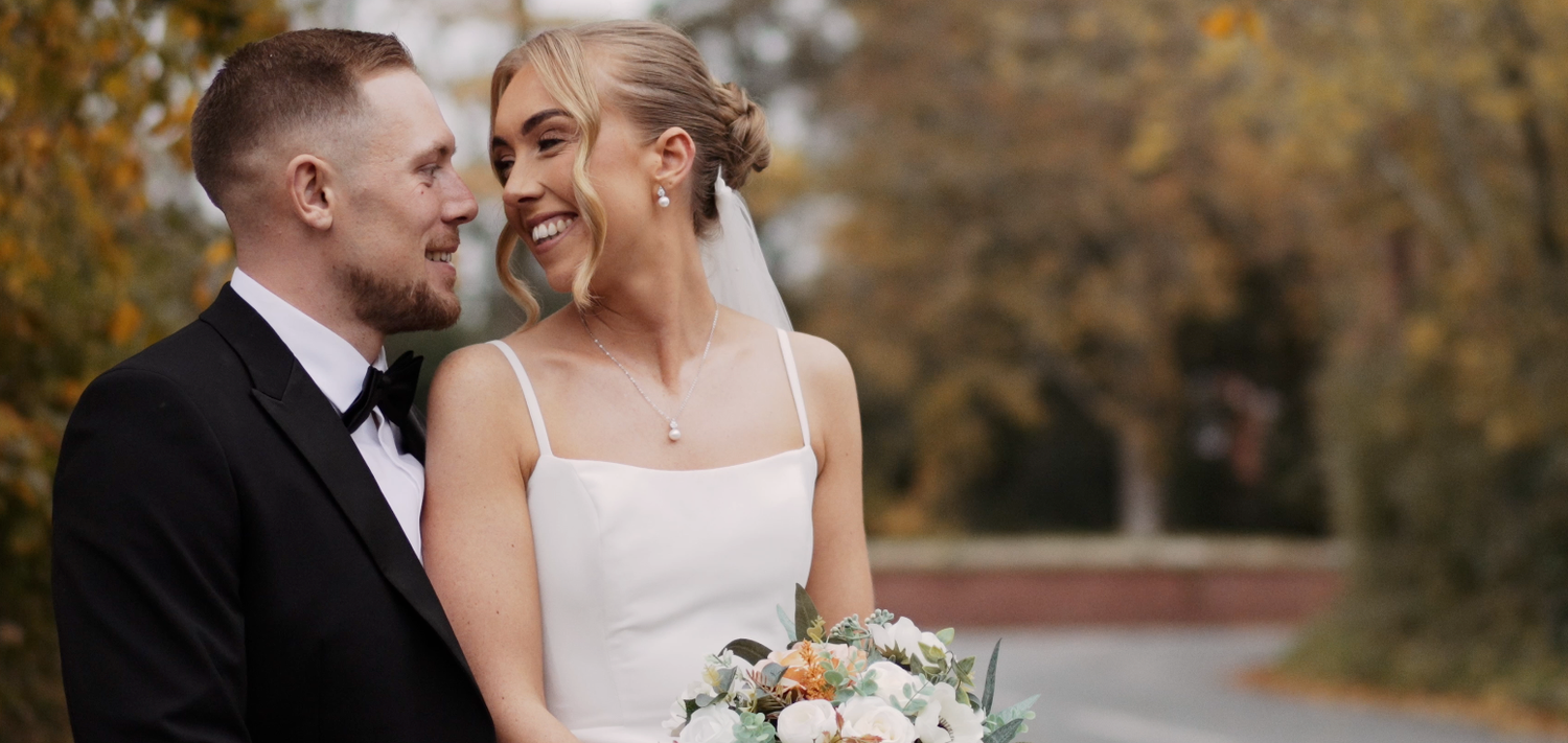 Autumn wedding portrait session with fall foliage creating a romantic backdrop.