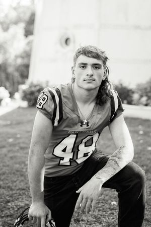 Black and white portrait of athlete in Panthers jersey number 48.