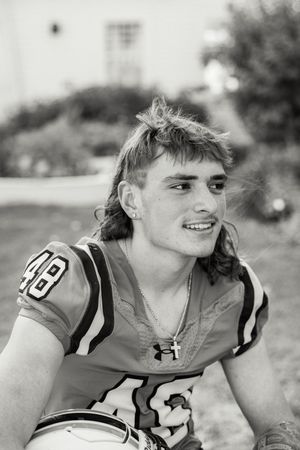 Black and white close-up of athlete in Panthers jersey.