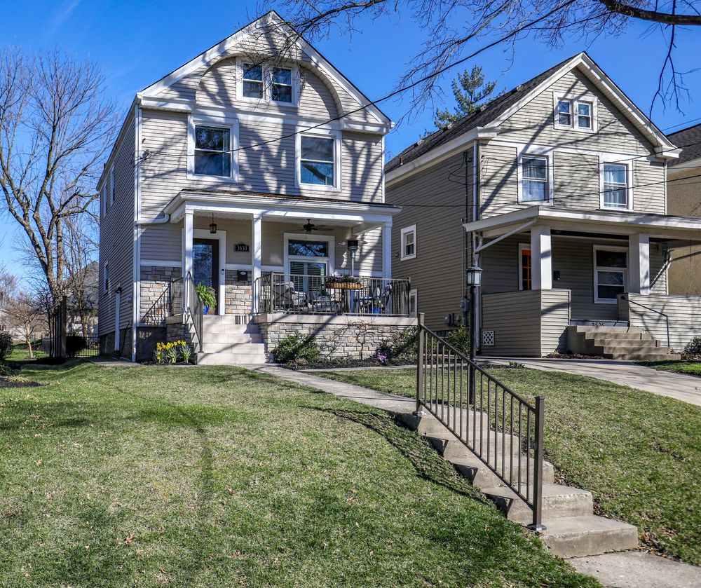 A series of connected images showing a white craftsman style house with black railings on a grassy hill in a residential area.
