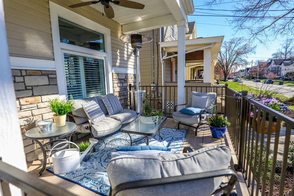 Cozy screened porch with wicker furniture and ceiling fan creates a relaxing outdoor living space in warm weather.
