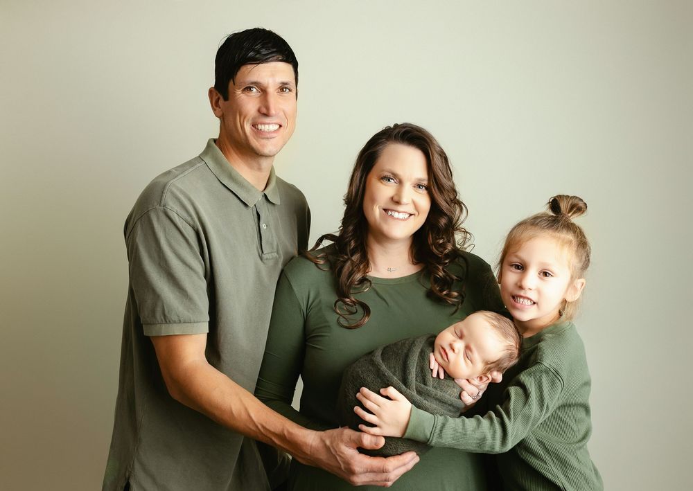 The entire family is holding the newborn boy. - Greenville, SC newborn photographer - Easley, SC newborn photographer.