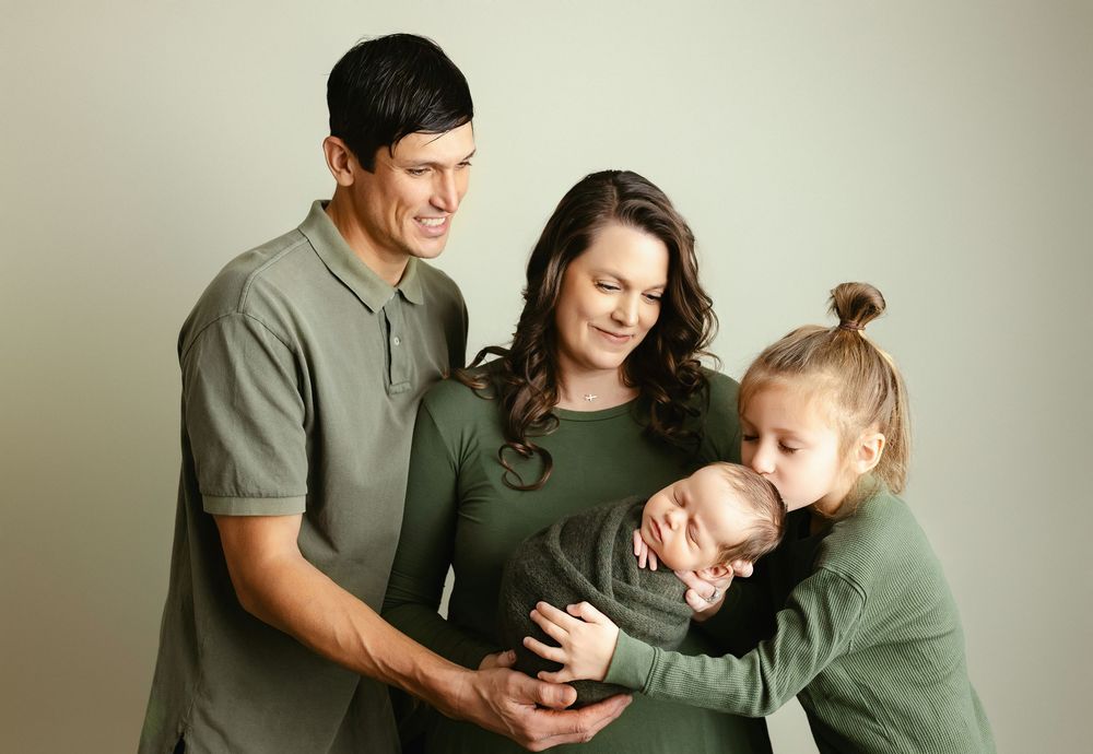 Family looking so lovingly while big brother kissing newborn. - Greenville, SC newborn photographer - Easley, SC newborn photographer.