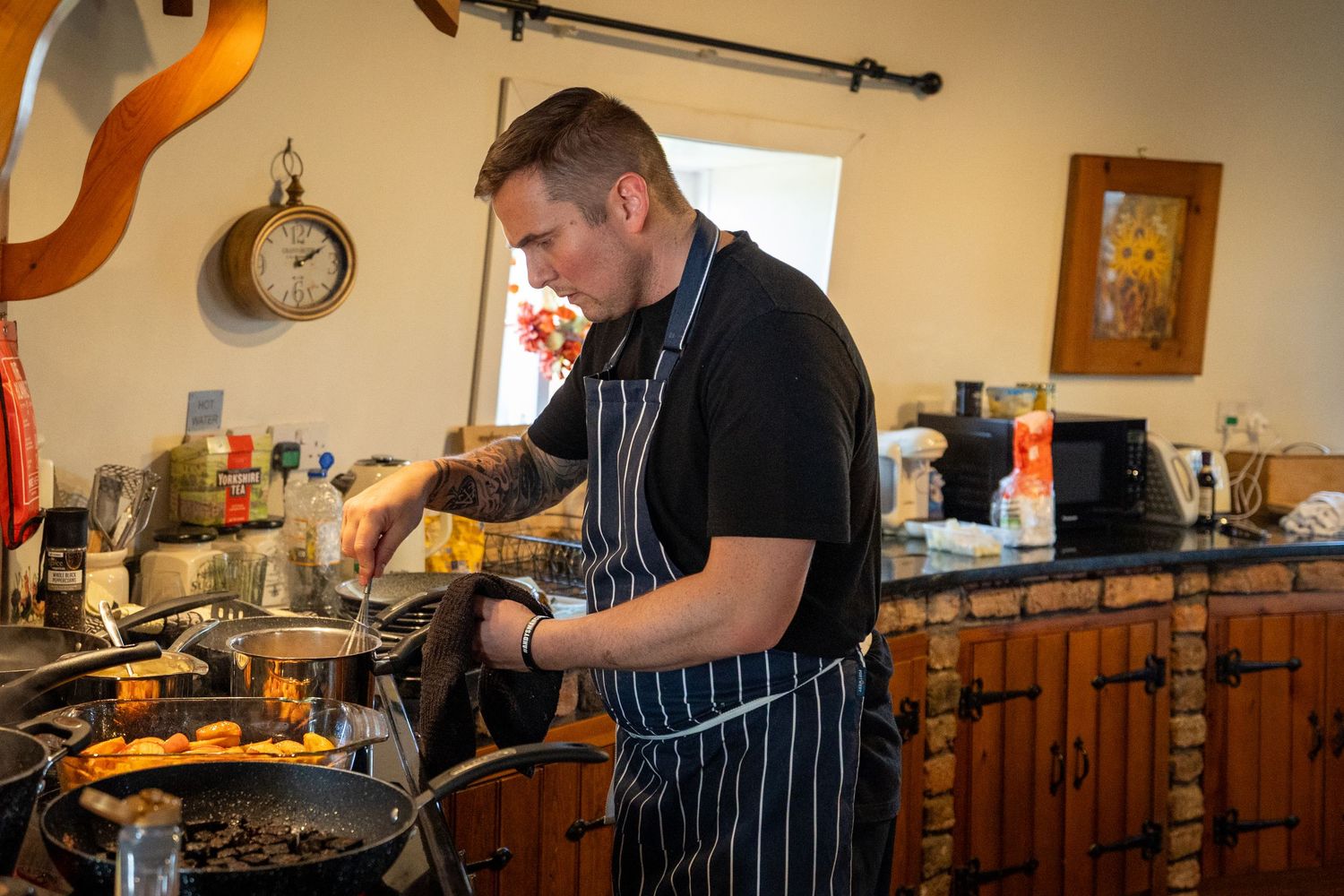 Private chef cooking at a relaxed wedding breakfast in Windmill Farm kitchen in Burscough.