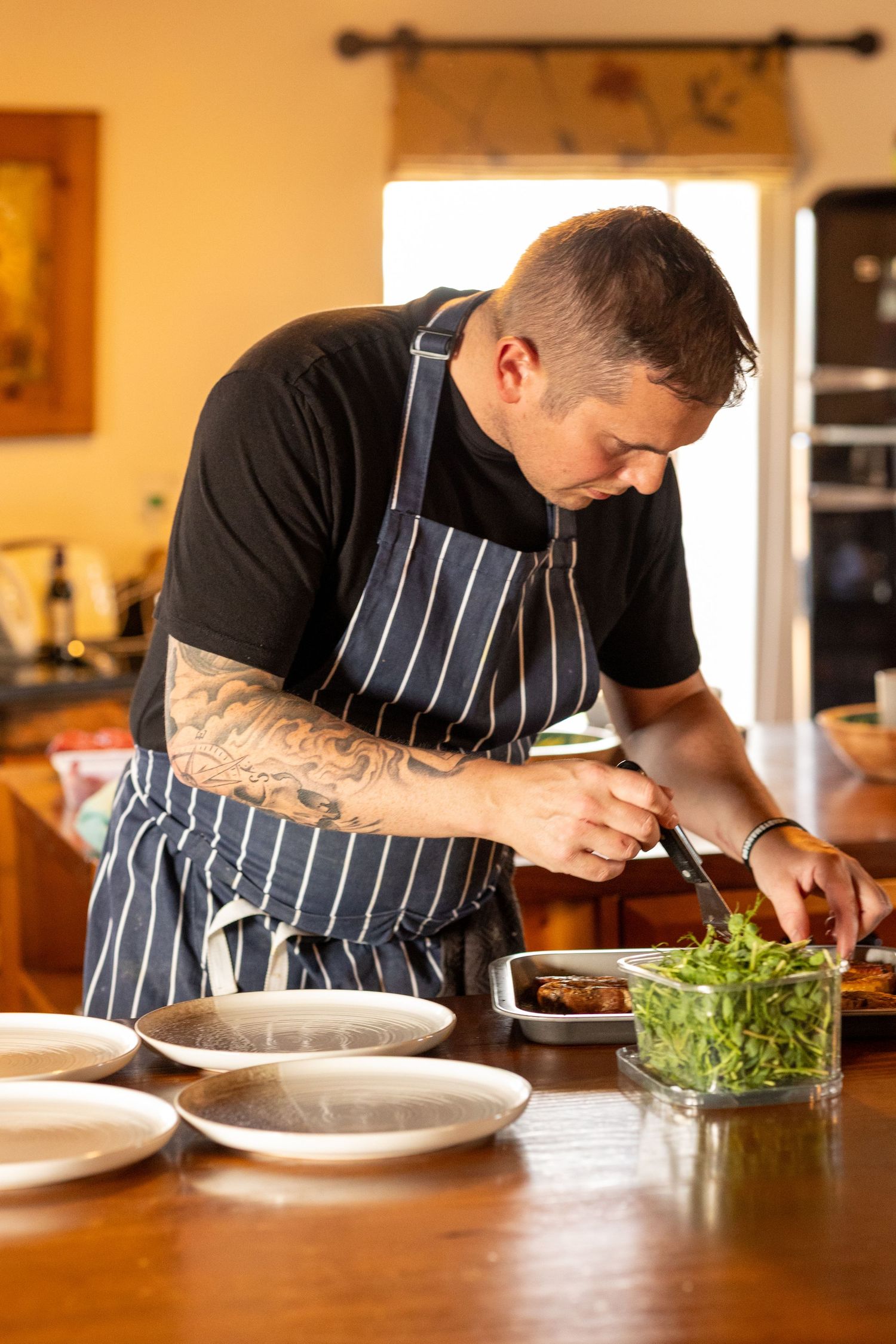 Private chef preparing and plating food during relaxed wedding breakfast at The Windmill Burscough