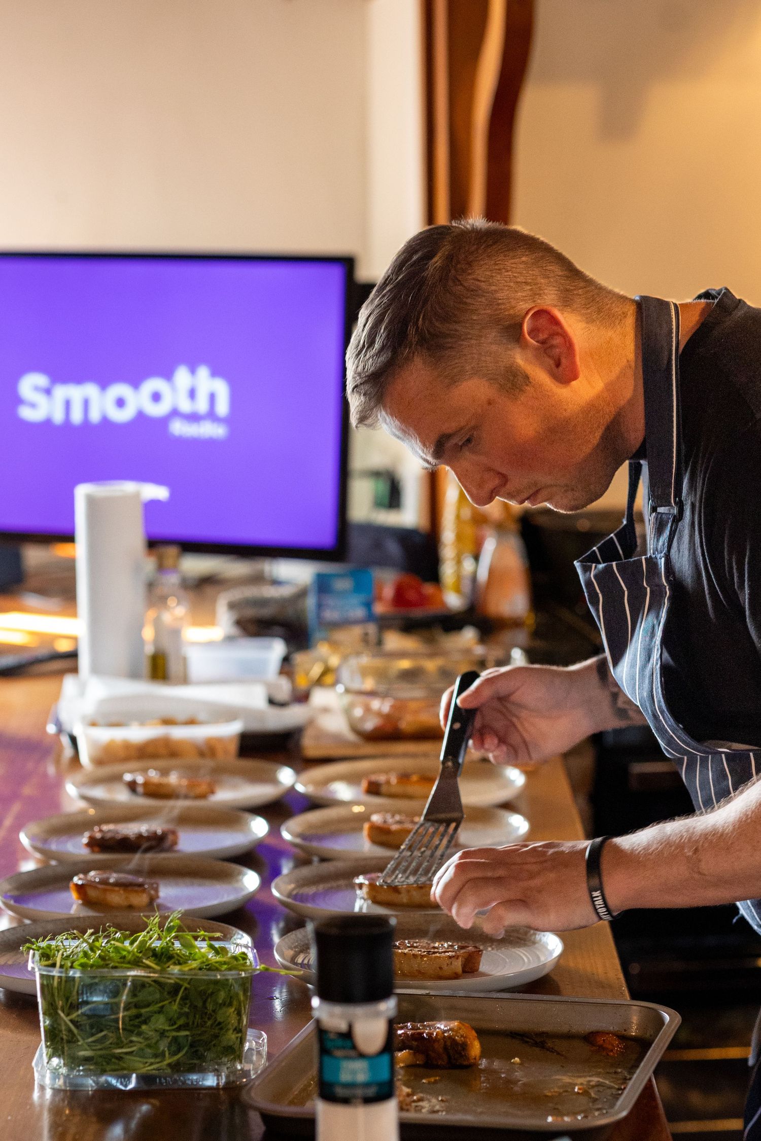Chef plating wedding breakfast dishes in a rustic kitchen at The Windmill Burscough wedding