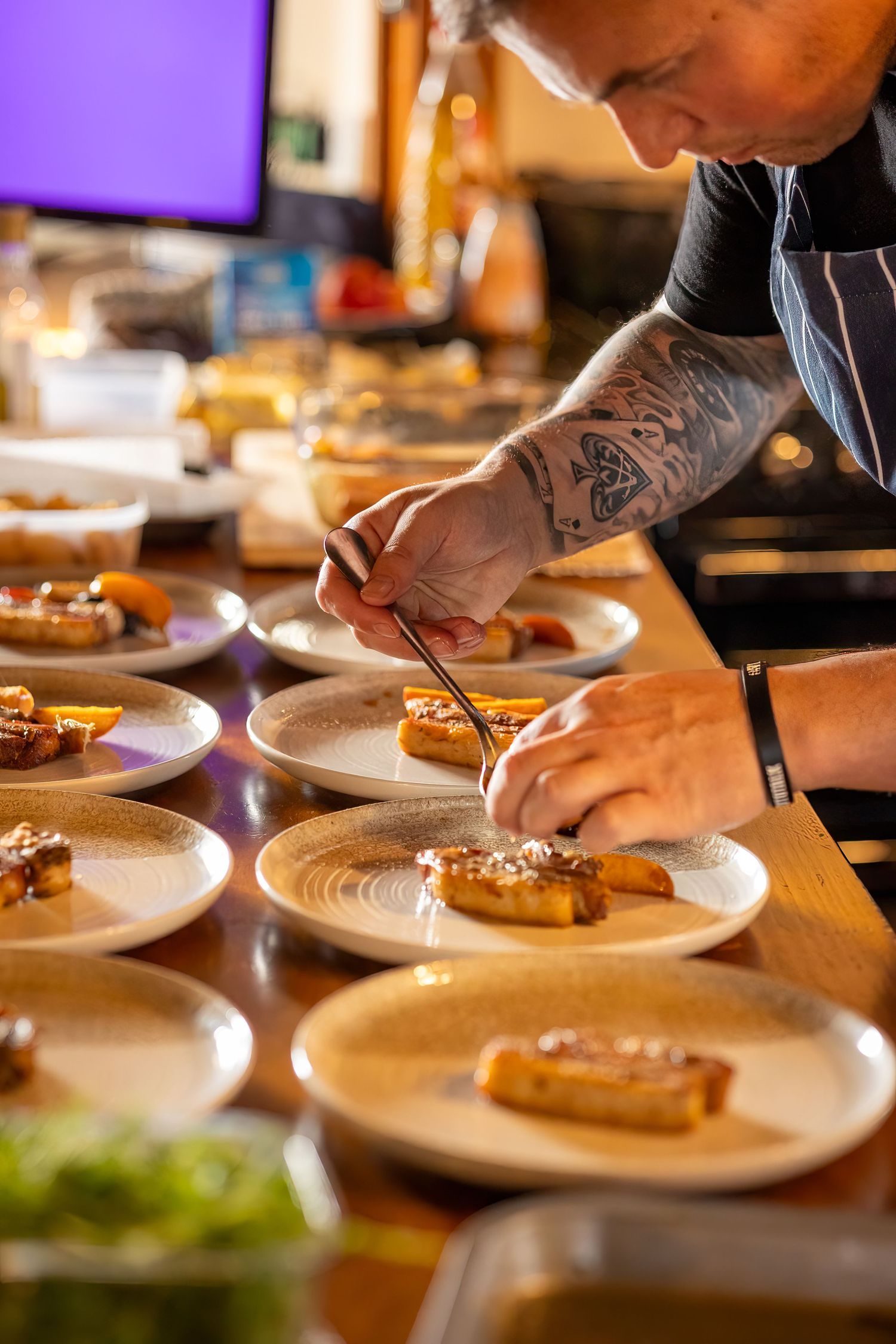 Close up of chef finishing plates for intimate wedding meal at The Windmill Burscough