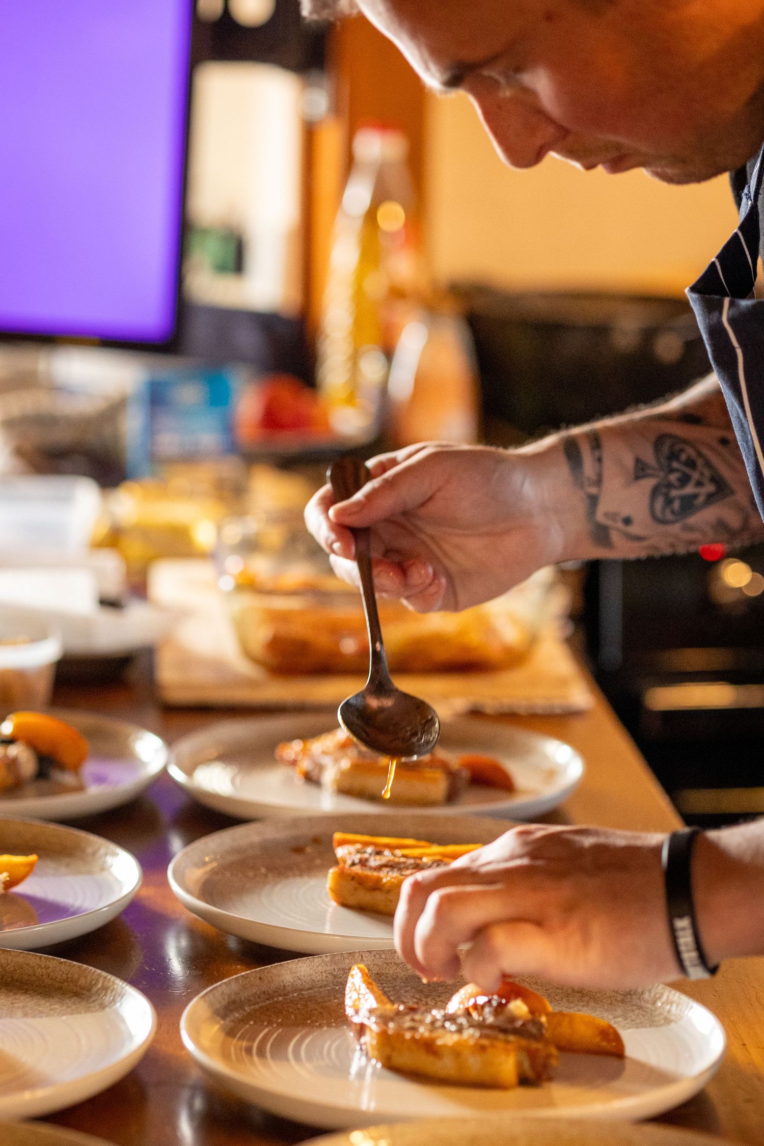 Chef plating wedding breakfast dishes in a cosy kitchen at The Windmill Burscough during a relaxed documentary wedding