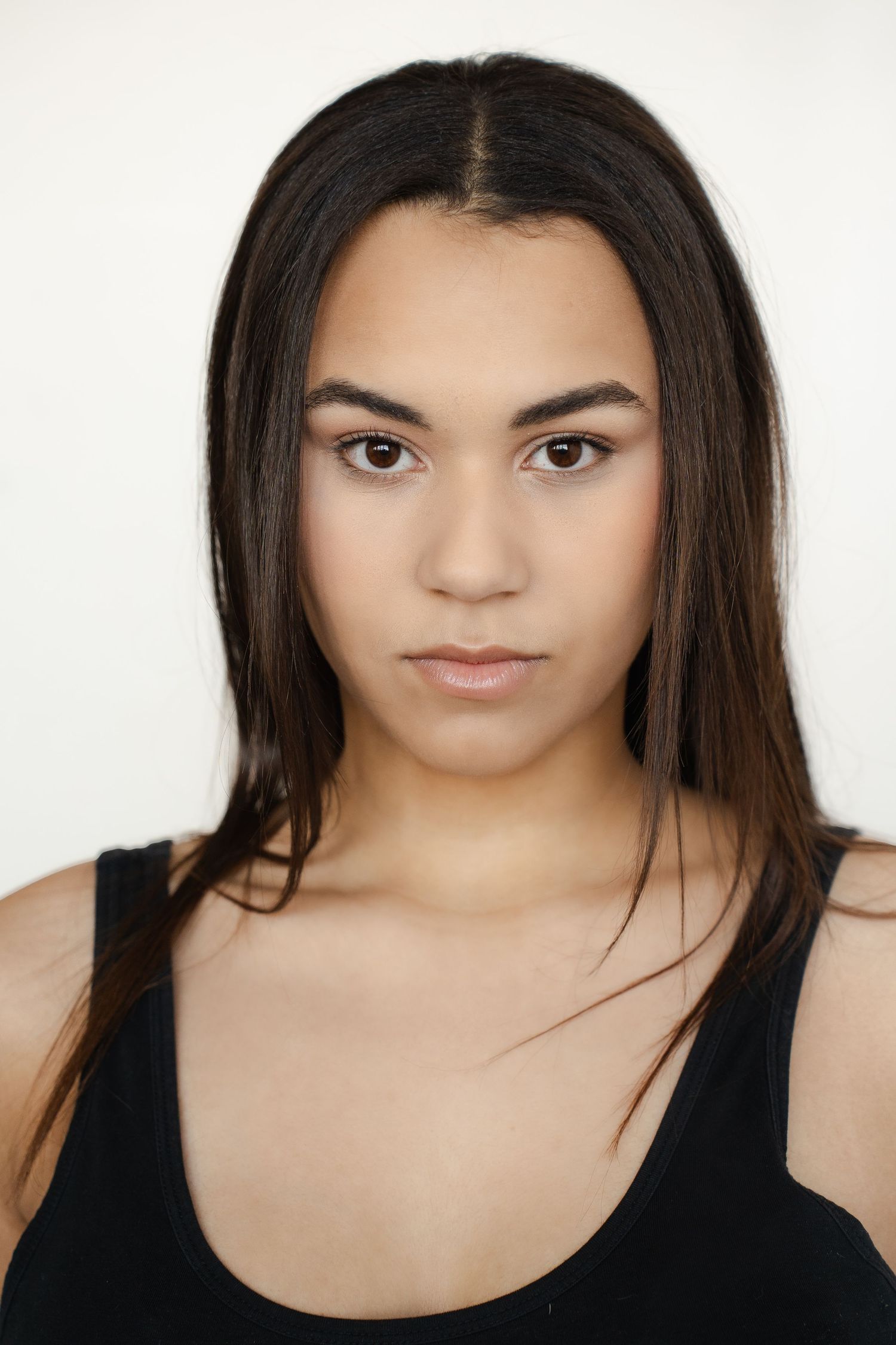 A series of headshots showing someone with long dark hair wearing a black top against a white background.