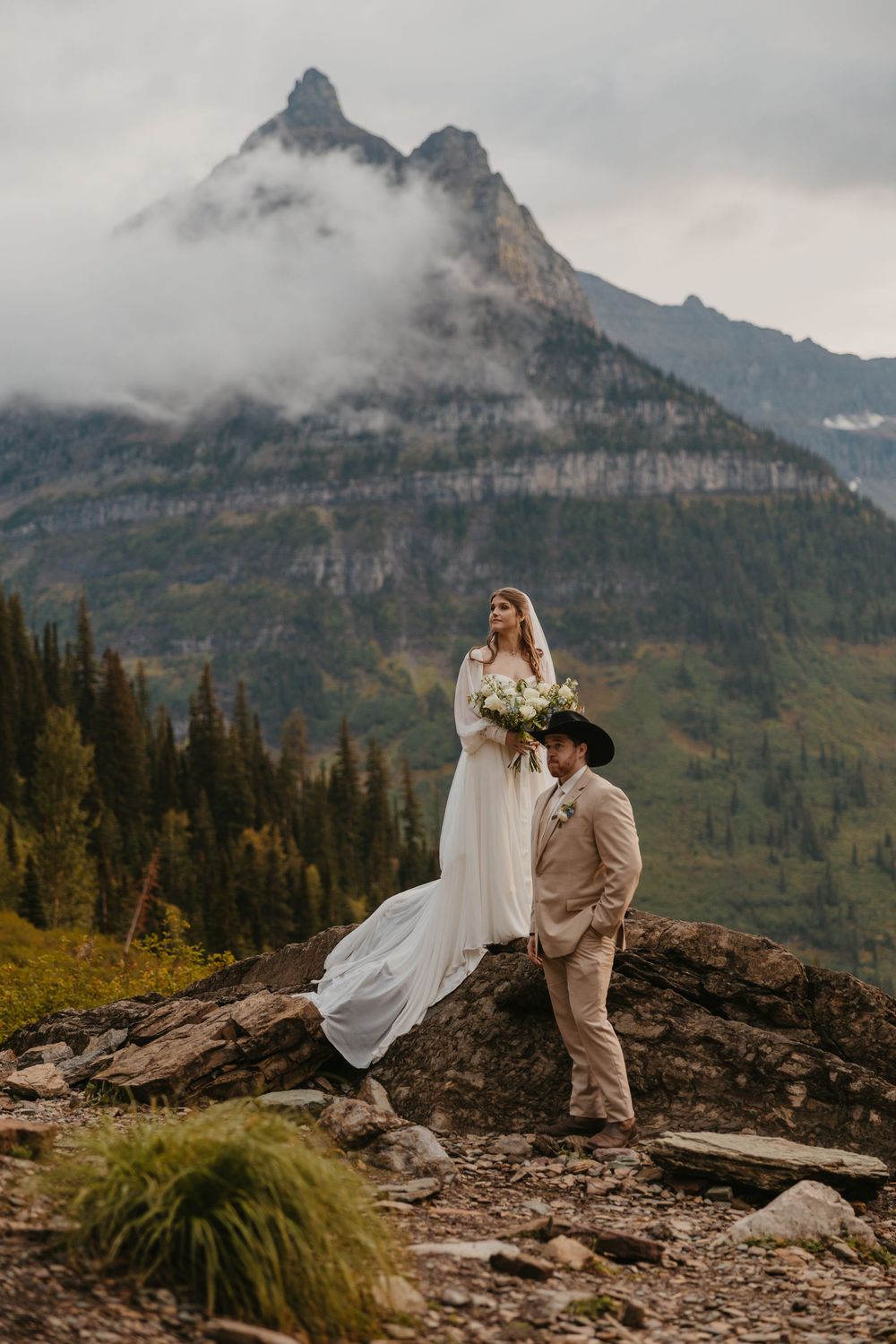 Glacier National Park Eloping Bride and Groom looking off at the mountains at Big Bend,  by local Elopement Photographer Sabrina Marie