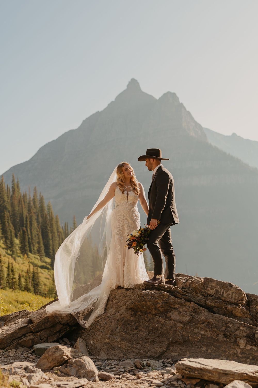 Glacier National Park Eloping Bride and Groom enjoying the view of Big Bend, captured by local Elopement Photographer Sabrina Marie