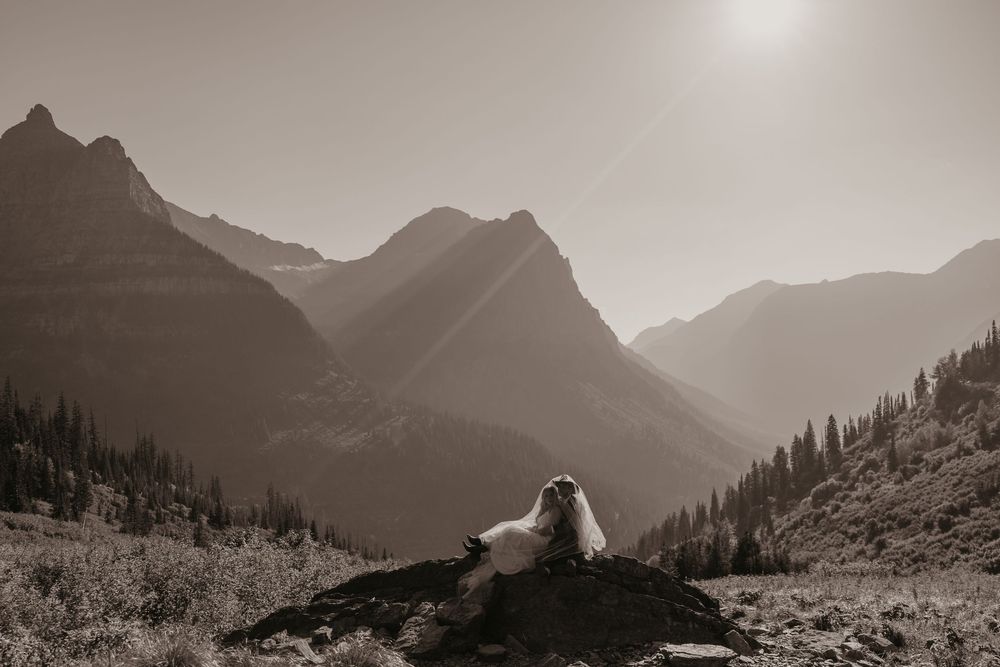Glacier National Park Eloping Bride and Groom cuddling on Big Bend, captured by local Elopement Photographer Sabrina Marie
