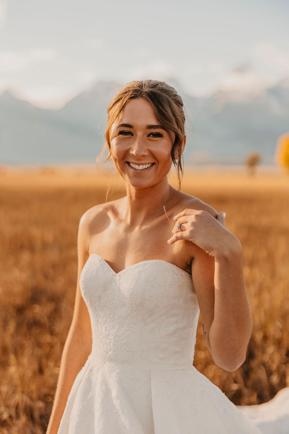 Bride smiling on her elopement day under the fall sunset captured by a Grand Teton National Park Elopement Photographer - Jackson Hole
