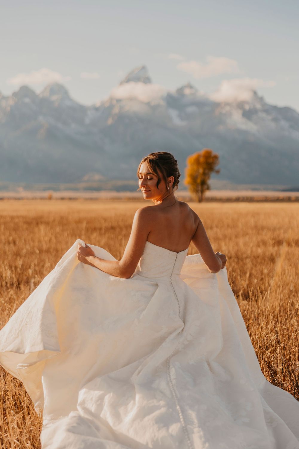 Bride running into the Tetons on her elopement day captured by a Grand Teton National Park Elopement Photographer - Jackson Hole