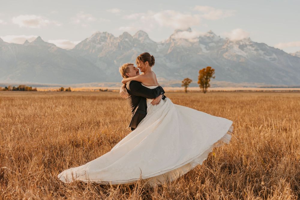 Bride and Groom dancing under the Tetons in the fall sunset captured by a Grand Teton National Park Elopement Photographer