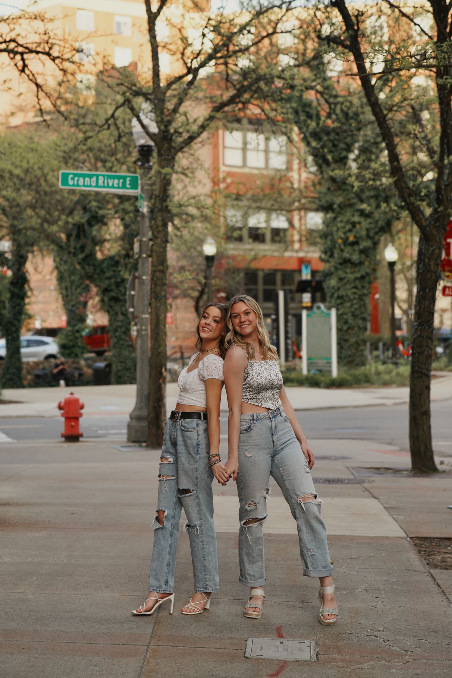 Friends photoshoot in Detroit streets with urban buildings and natural light