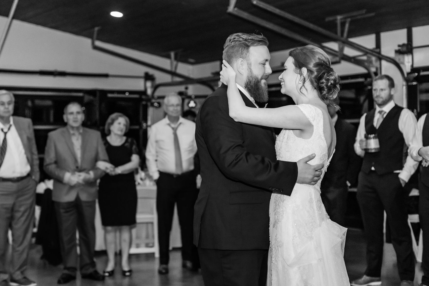 Black and white wedding reception photos show couples dancing and celebrating together on the dance floor.