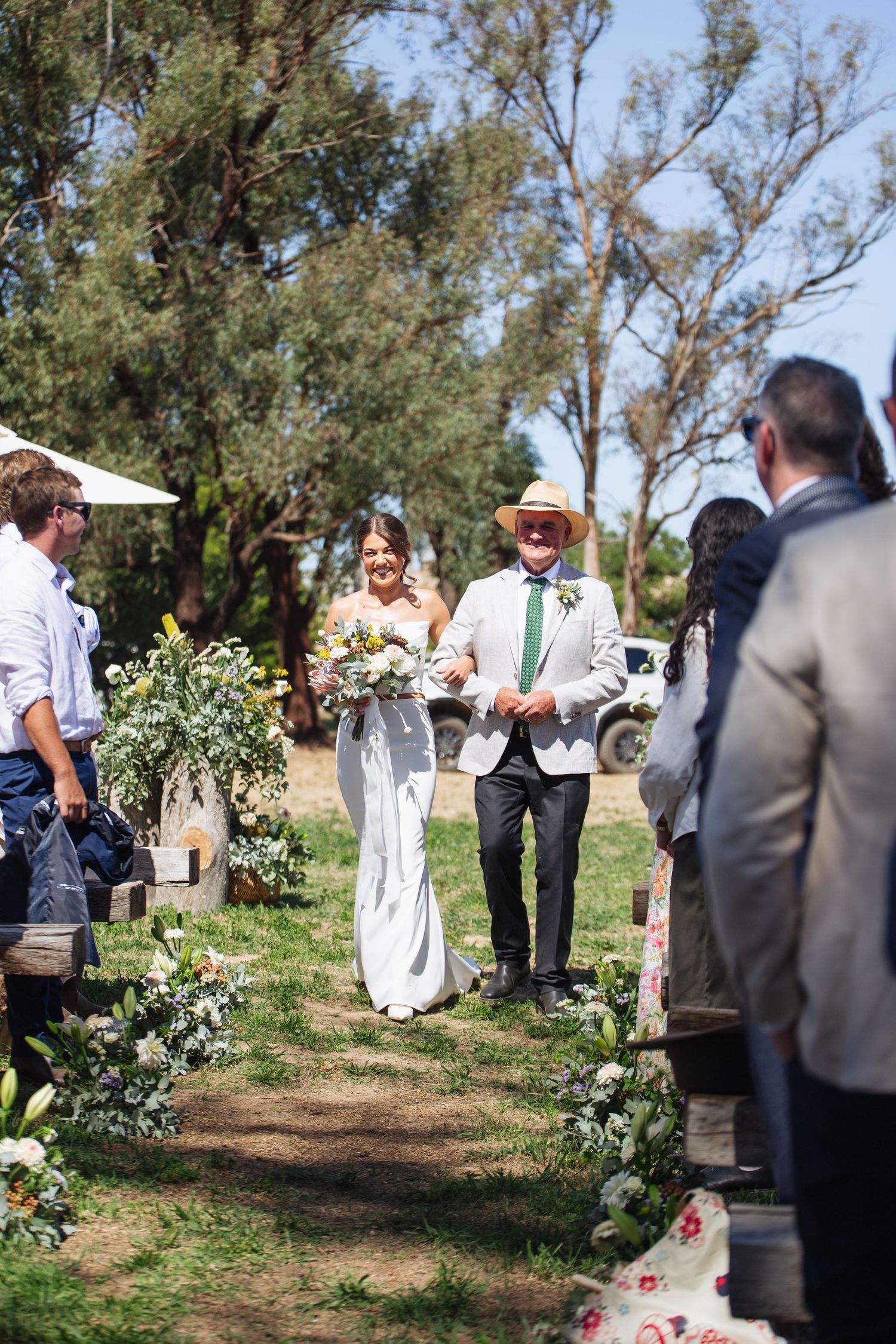 bride and father of the bride walking down the aisle linking arms at country NSW wedding