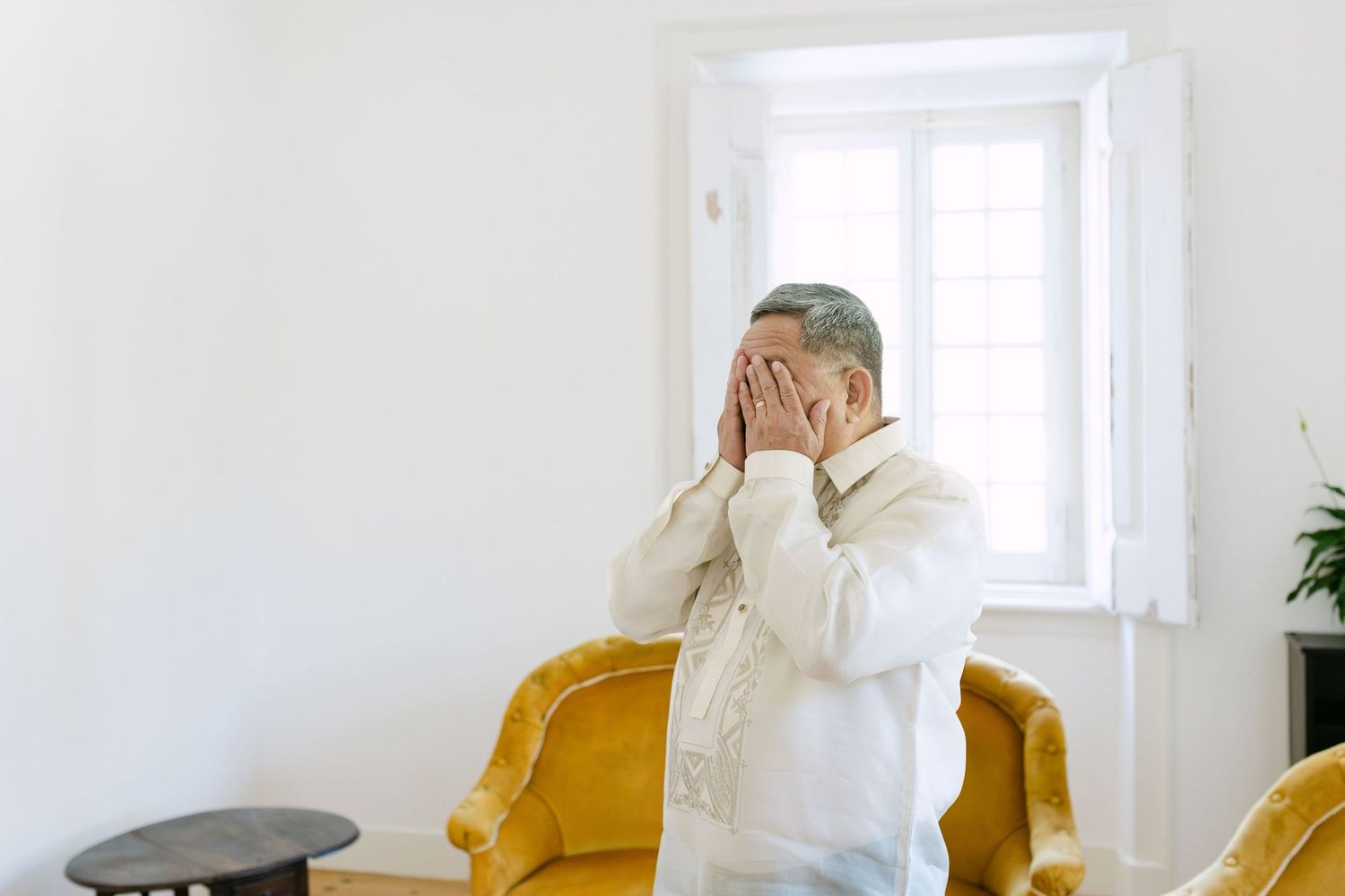 Father figure covering his face with emotion during first look with bride in Lisbon wedding morning