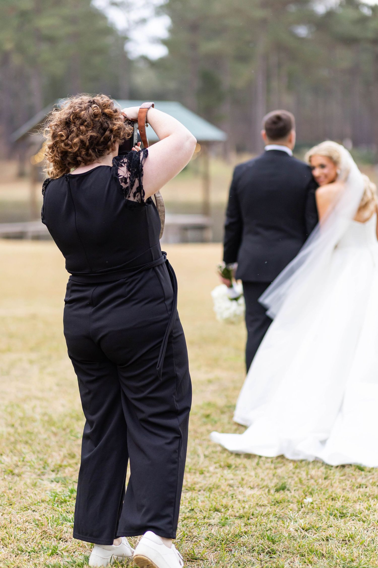 photographer with bride and groom
