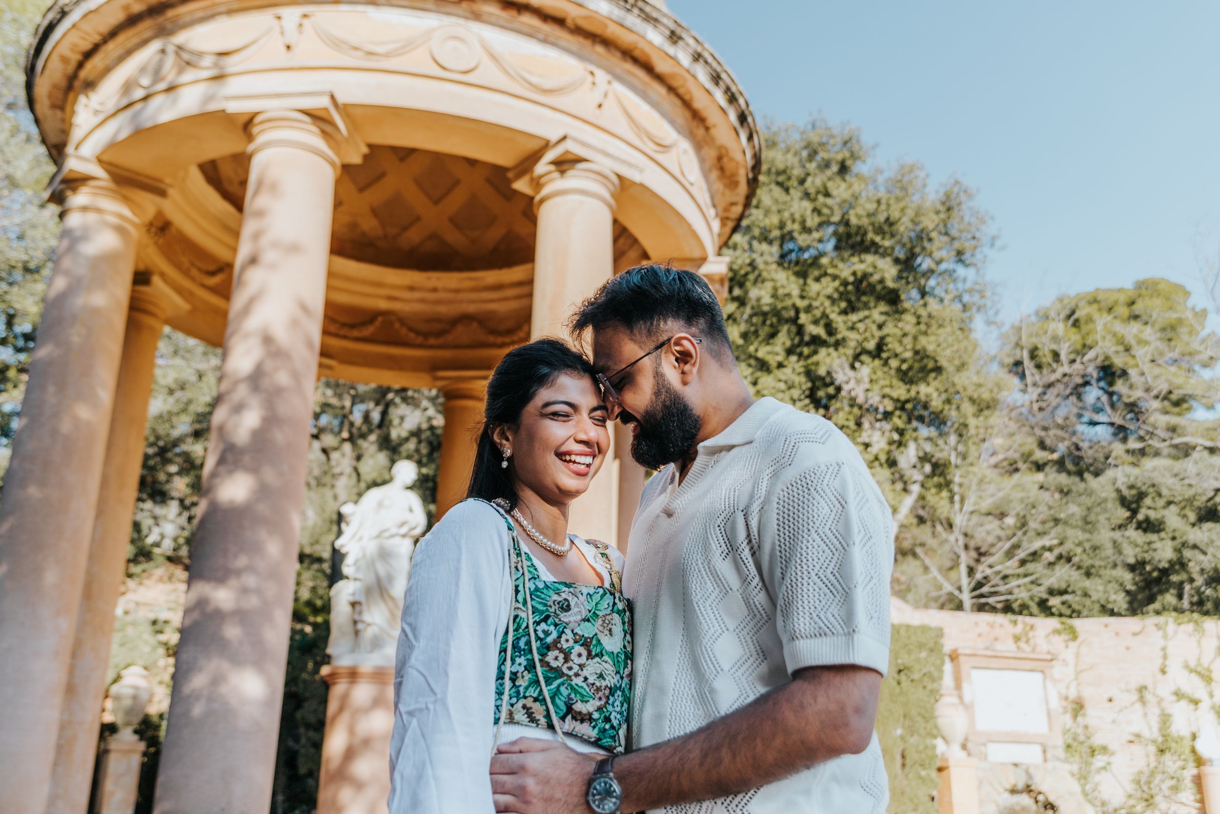 Romantic couple walking through historic gardens in Barcelona