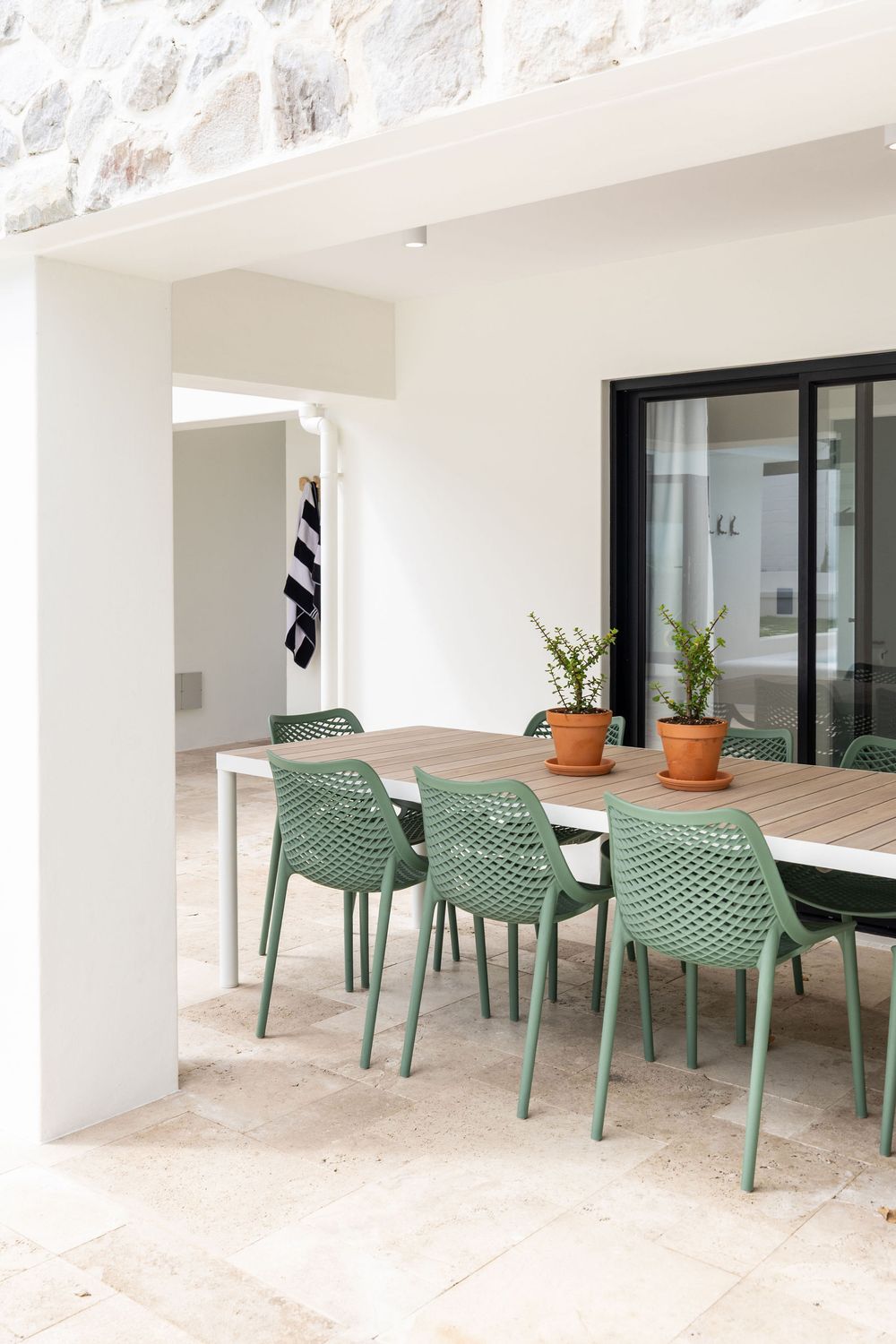 Coastal home outdoor entertainment area with braai and seating