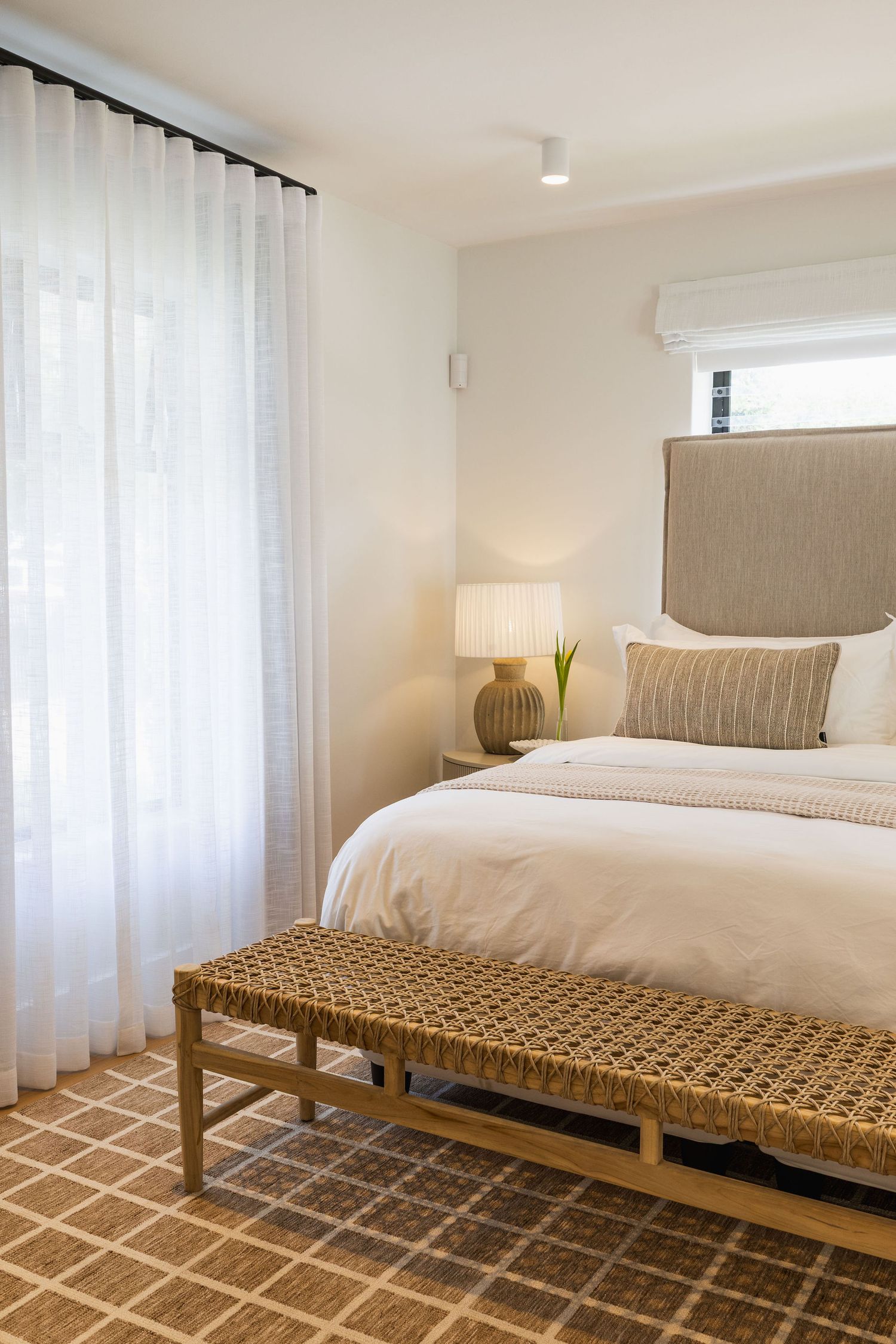 Coastal bedroom with white linen bedding and soft natural textures