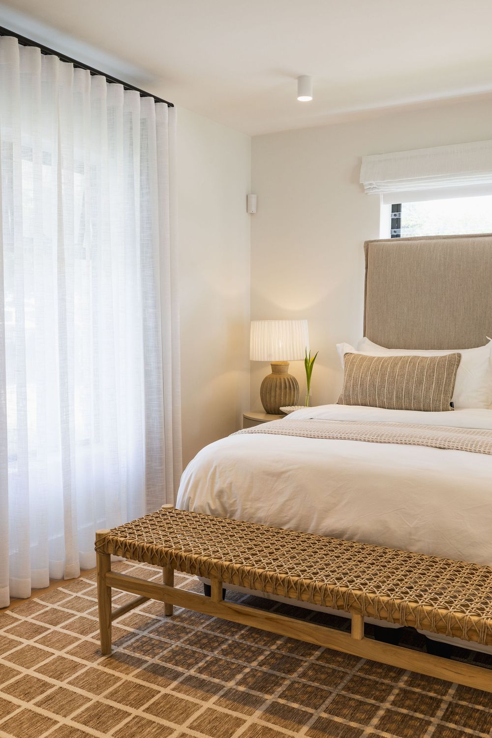 Coastal bedroom with white linen bedding and soft natural textures